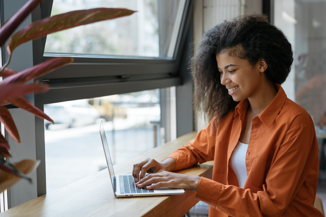 young adult female applying for job with her laptop