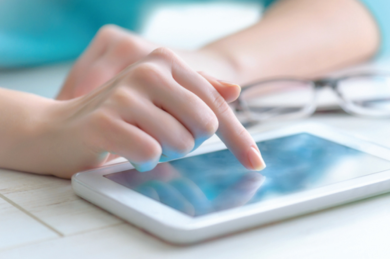 close up of tablet users' hands while using tablet for online banking